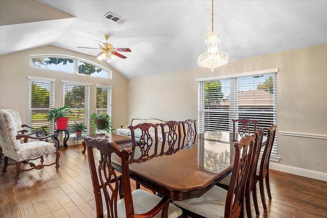 2098 Amber Ct, Lewisville, TX 75067 - dining area featuring lofted ceiling, a ceiling fan, hardwood / wood-style flooring, a chandelier, and baseboards