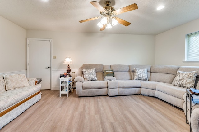 1513 Silverleaf Dr, Carrollton, TX 75007 - living area with wood finished floors, a ceiling fan, a textured ceiling, wainscoting, and recessed lighting