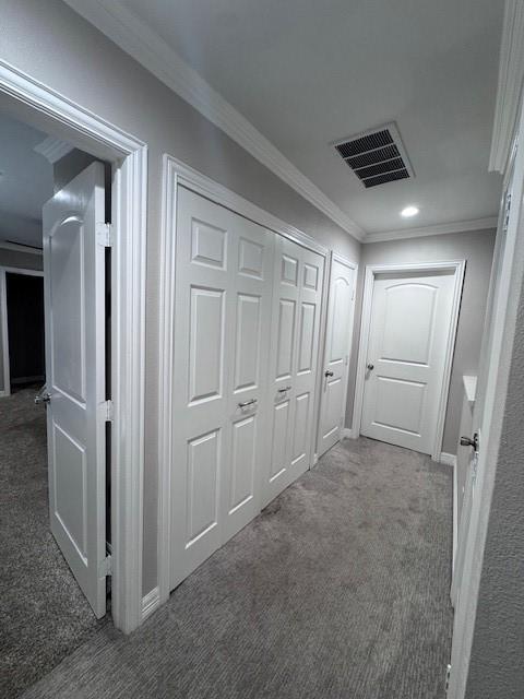 hallway with carpet floors, crown molding, and recessed lighting