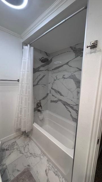 full bathroom with marble finish flooring, ornamental molding, shower / bath combo with shower curtain, and baseboards