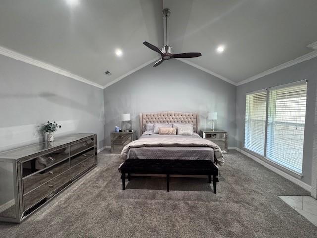 bedroom with baseboards, lofted ceiling, ornamental molding, a ceiling fan, and carpet flooring