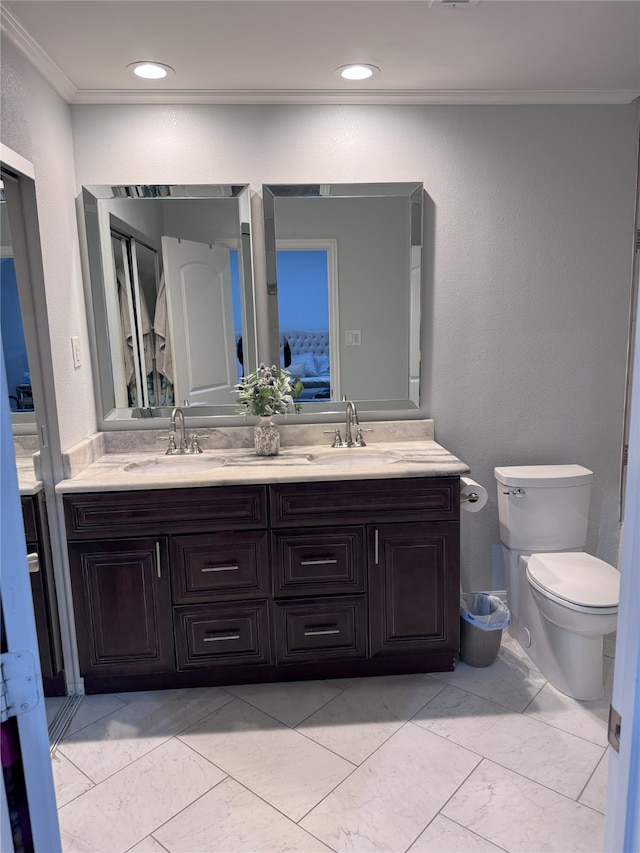 full bath featuring ornamental molding, marble look tiles, double vanity, toilet, and ensuite bath