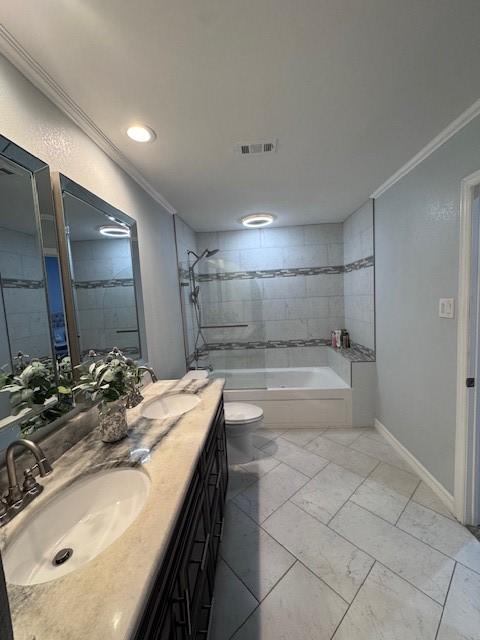 bathroom with ornamental molding, toilet, shower / tub combination, baseboards, and double vanity