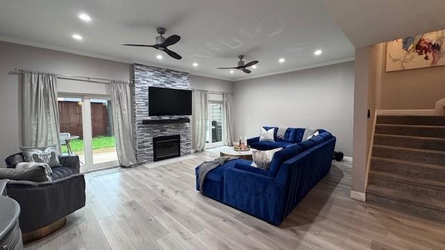 living room featuring ornamental molding, stairs, ceiling fan, recessed lighting, and light wood finished floors