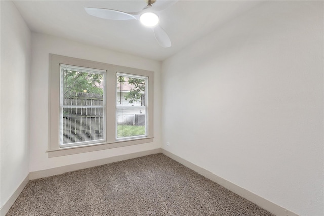 carpeted empty room featuring ceiling fan and baseboards