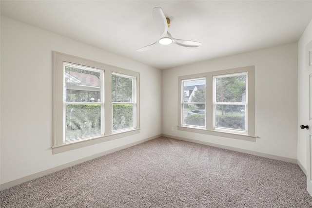 carpeted empty room featuring ceiling fan