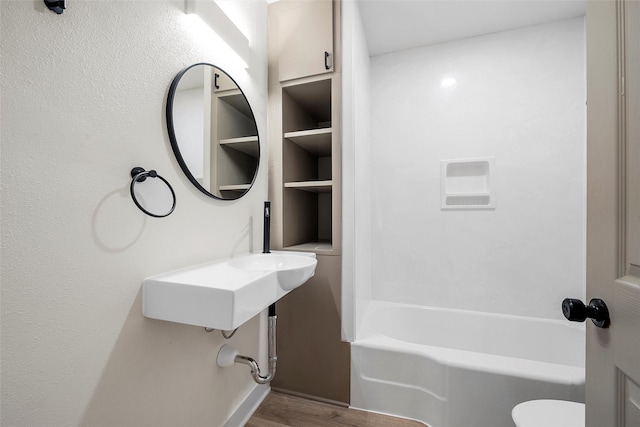 bathroom featuring wood finished floors and toilet