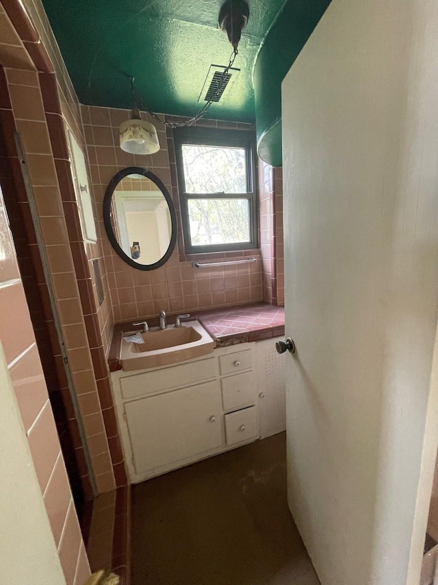 bathroom featuring vanity and backsplash