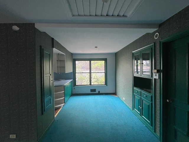 unfurnished living room with light carpet and baseboards