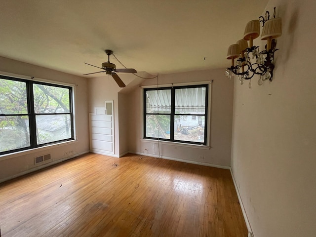 spare room with light wood-type flooring, baseboards, and ceiling fan