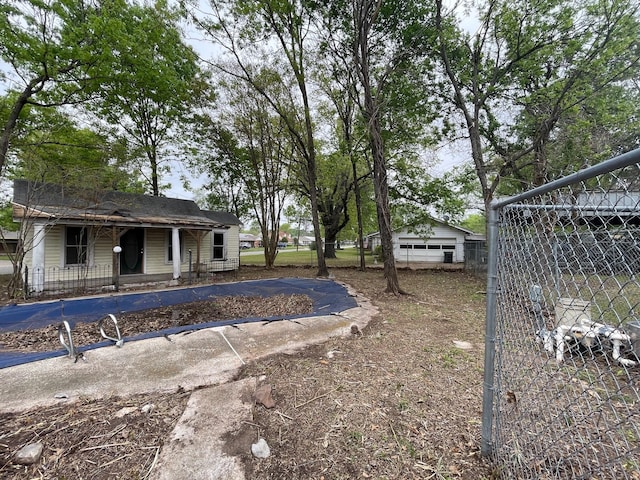 view of yard featuring fence and a porch