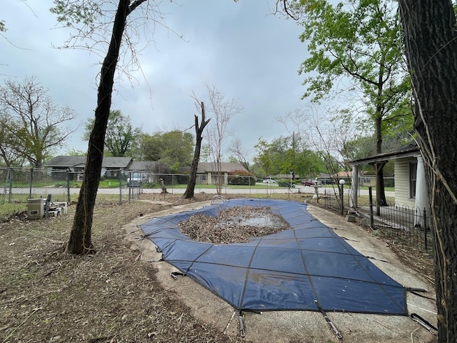 view of swimming pool with fence