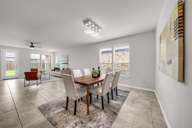 3433 Alamosa River Dr, Celina, TX 75078 - dining area with light tile patterned floors, baseboards, ceiling fan, and a chandelier