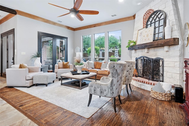 4290 Castle Bank Ln, Frisco, TX 75033 - living room featuring crown molding, a ceiling fan, a brick fireplace, and wood finished floors