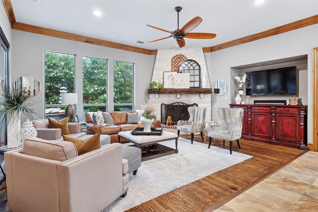 4290 Castle Bank Ln, Frisco, TX 75033 - living room with ornamental molding, a ceiling fan, a brick fireplace, and recessed lighting