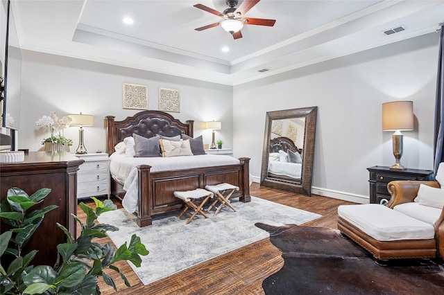 4290 Castle Bank Ln, Frisco, TX 75033 - bedroom with baseboards, wood finished floors, ornamental molding, a tray ceiling, and recessed lighting