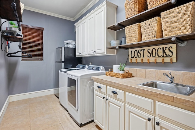 4290 Castle Bank Ln, Frisco, TX 75033 - washroom featuring washer and dryer, cabinet space, ornamental molding, baseboards, and light tile patterned flooring