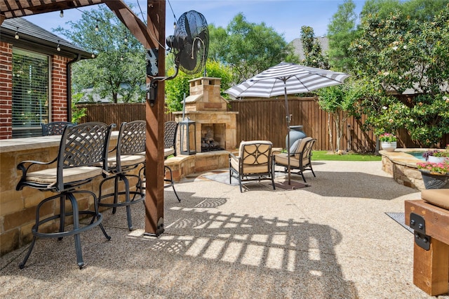 4290 Castle Bank Ln, Frisco, TX 75033 - view of patio with an outdoor stone fireplace and fence
