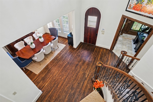 4290 Castle Bank Ln, Frisco, TX 75033 - foyer entrance with wood finished floors, healthy amount of natural light, baseboards, arched walkways, and a towering ceiling
