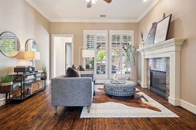 4290 Castle Bank Ln, Frisco, TX 75033 - living area featuring a ceiling fan, healthy amount of natural light, wood finished floors, a tile fireplace, and ornamental molding