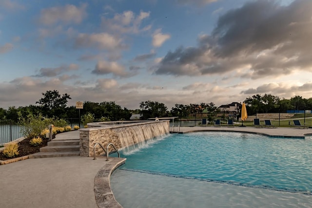 618 Race Dr, Heath, TX 75126 - pool at dusk featuring fence, a patio area, and a community pool