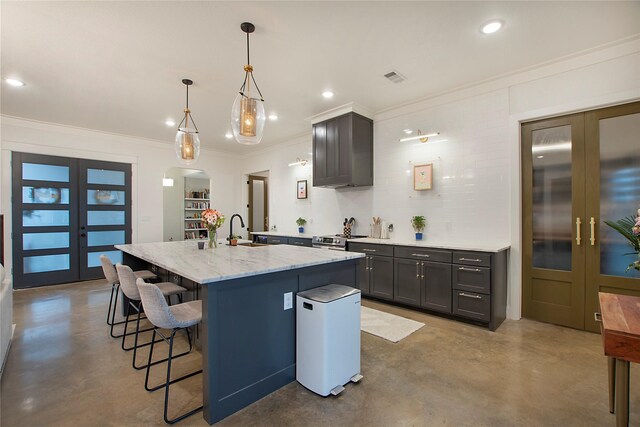 kitchen with finished concrete flooring, french doors, a sink, light stone counters, and ornamental molding