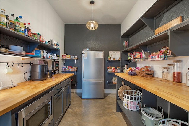 kitchen featuring wood counters, stainless steel appliances, and open shelves