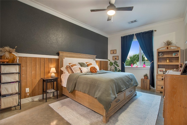 bedroom with crown molding, wood walls, and a ceiling fan