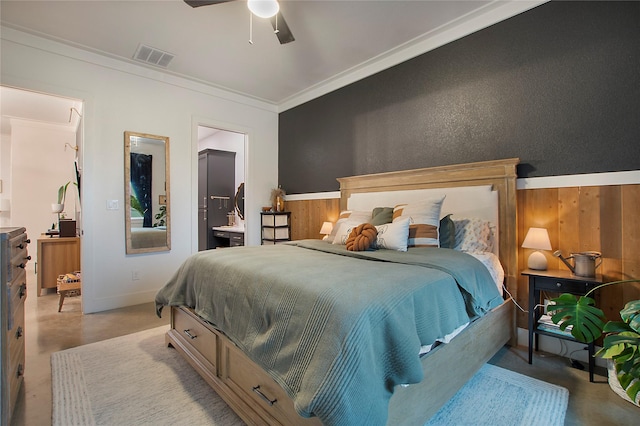 bedroom with ornamental molding, concrete flooring, a ceiling fan, baseboards, and ensuite bathroom