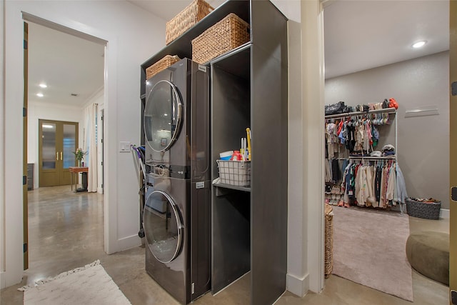 clothes washing area with stacked washer / drying machine, baseboards, recessed lighting, crown molding, and french doors