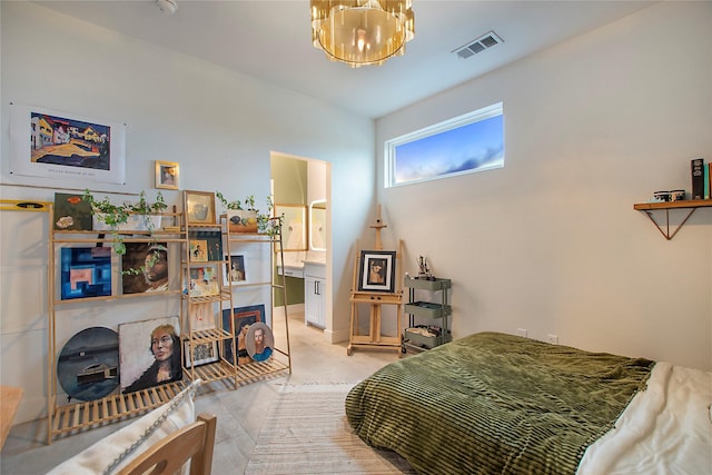 bedroom featuring a chandelier and ensuite bathroom