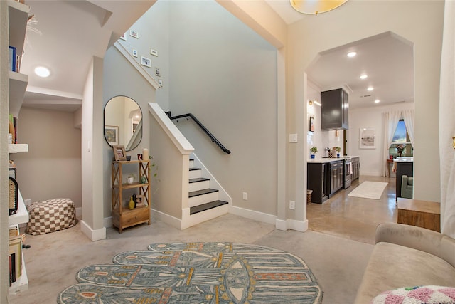 entrance foyer featuring stairs, baseboards, recessed lighting, and light carpet