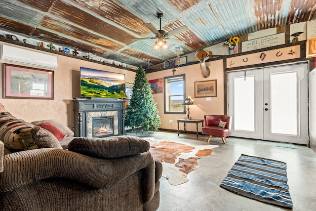 living room featuring a wall mounted AC, ceiling fan, a glass covered fireplace, and concrete floors