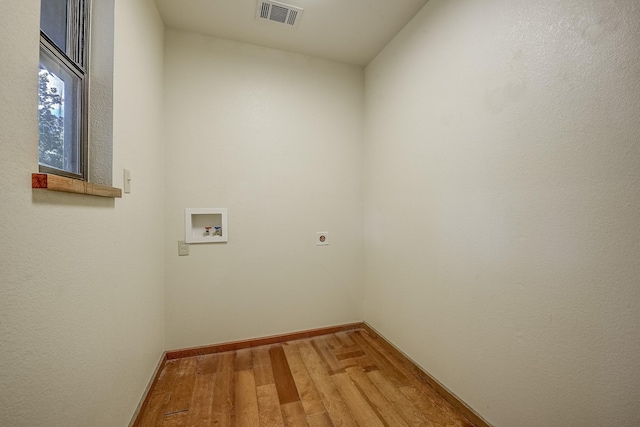 41 Crestline Ct, Nocona, TX 76255 - washroom with hookup for an electric dryer, hookup for a washing machine, light wood-style floors, and baseboards