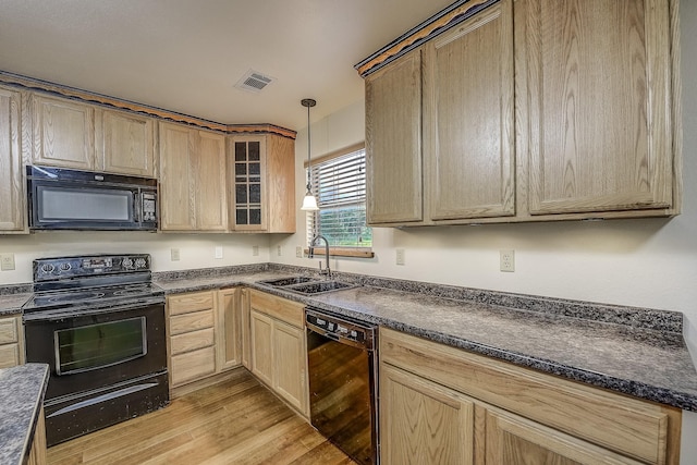 41 Crestline Ct, Nocona, TX 76255 - kitchen featuring black appliances, a sink, dark countertops, light wood-style floors, and light brown cabinetry