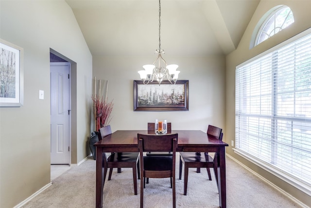 dining space with vaulted ceiling, a chandelier, light carpet, healthy amount of natural light, and baseboards