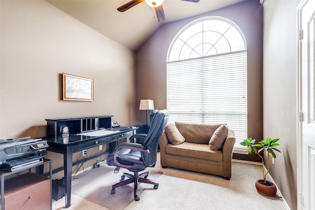 office space with a ceiling fan, carpet, and lofted ceiling