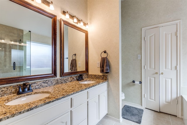 full bathroom featuring a shower stall, double vanity, tile patterned flooring, toilet, and baseboards
