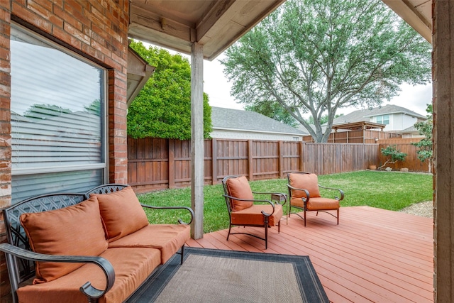 wooden terrace with an outdoor living space