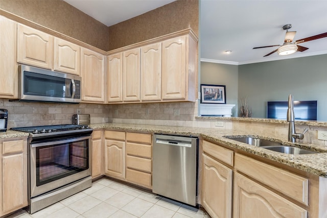 kitchen featuring light brown cabinetry, appliances with stainless steel finishes, a sink, and ornamental molding