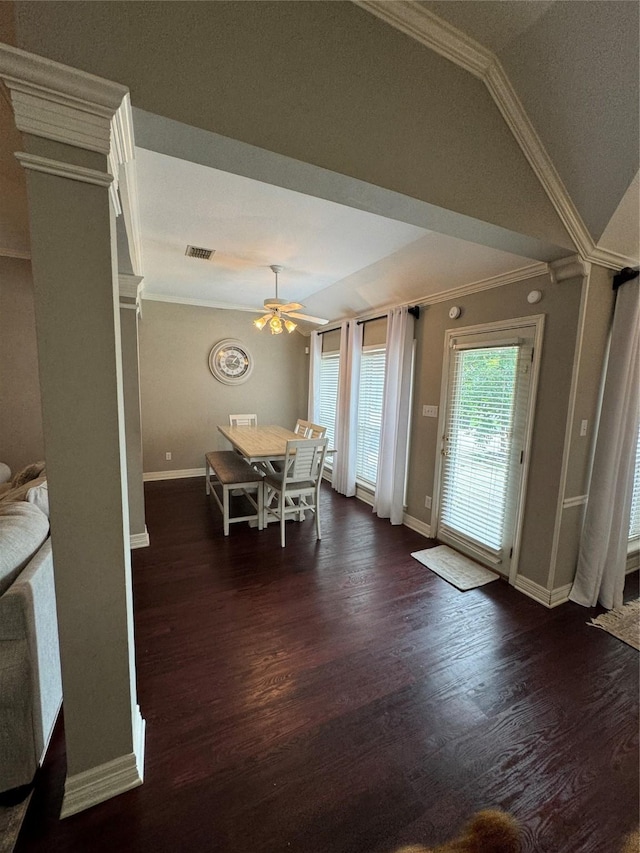 dining area with ornamental molding, a ceiling fan, baseboards, vaulted ceiling, and dark wood finished floors