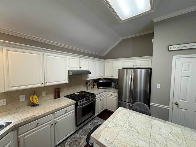 kitchen featuring stainless steel appliances, under cabinet range hood, lofted ceiling, crown molding, and white cabinets