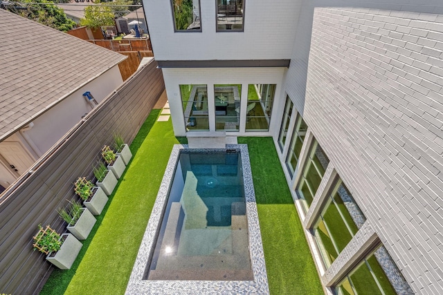 outdoor pool with a fenced backyard
