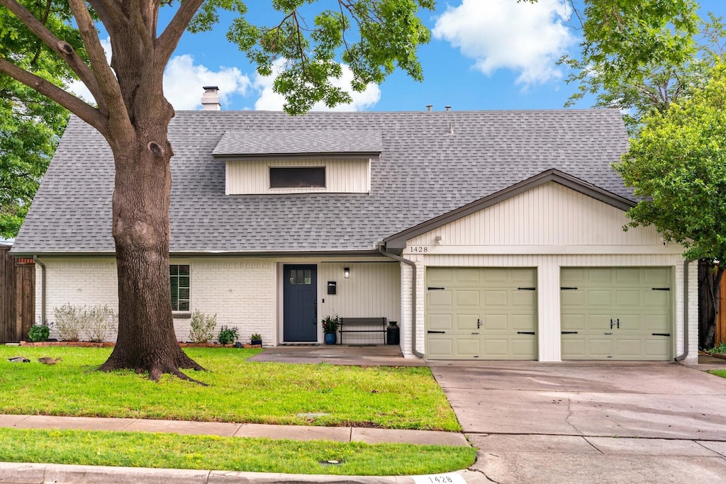 1428 Stagecoach Dr, Richardson, TX 75080 - view of front of home featuring a garage, driveway, a chimney, a front yard, and brick siding