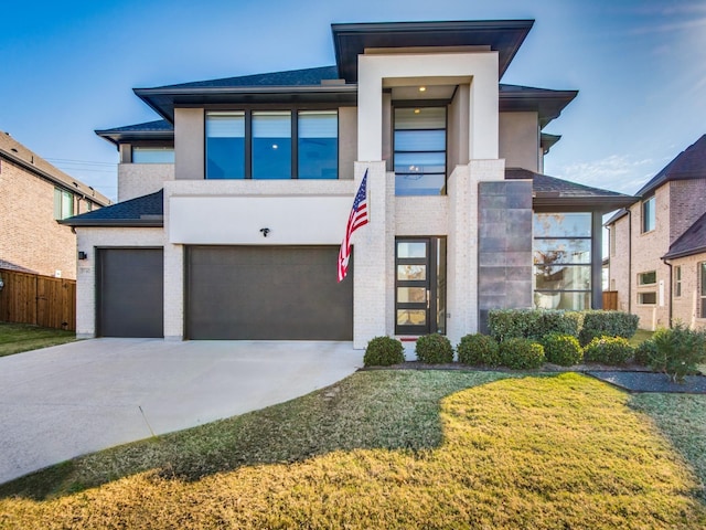 5160 Statesman Ln, Frisco, TX 75036 - view of front of house with an attached garage, driveway, brick siding, and stucco siding