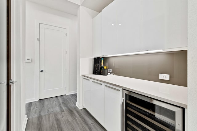 5160 Statesman Ln, Frisco, TX 75036 - bar featuring wine cooler, light wood-style floors, and baseboards