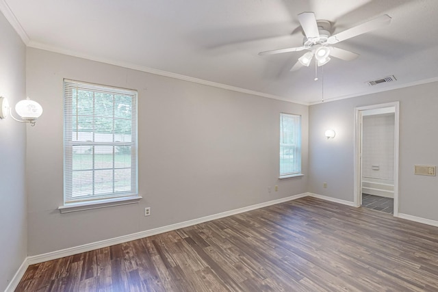 spare room featuring wood finished floors, ceiling fan, baseboards, and ornamental molding