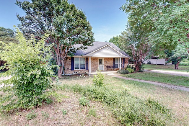 bungalow featuring brick siding, a front lawn, and a porch