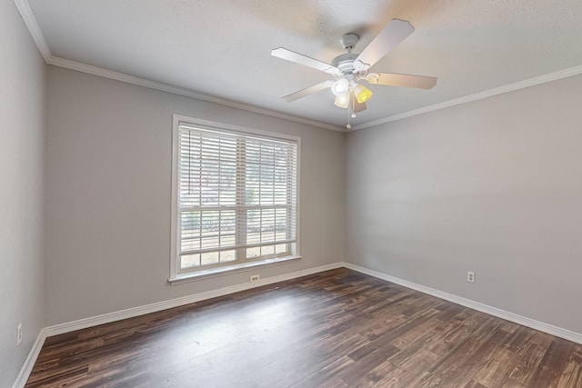 empty room featuring dark wood-style flooring, baseboards, crown molding, and ceiling fan