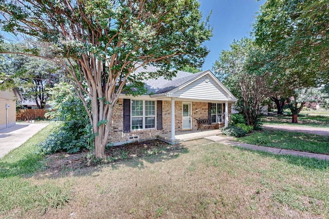 view of front of home with a front lawn, covered porch, and brick siding